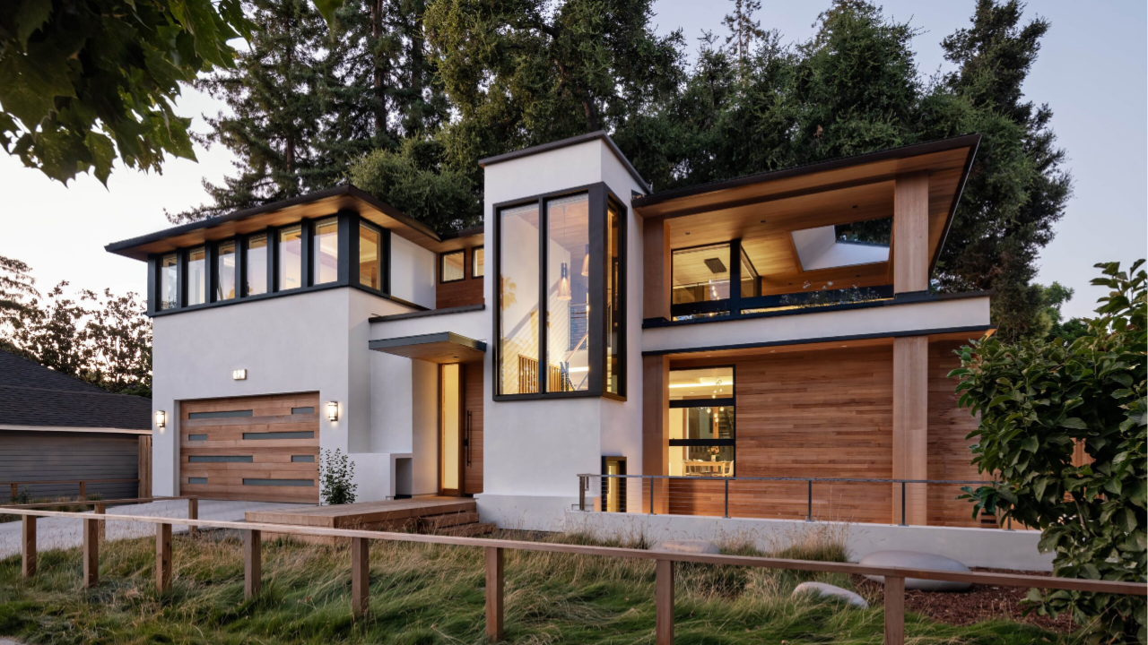 Modern custom home with large windows and timber cladding showing how structural engineering supports complex architectural design elements