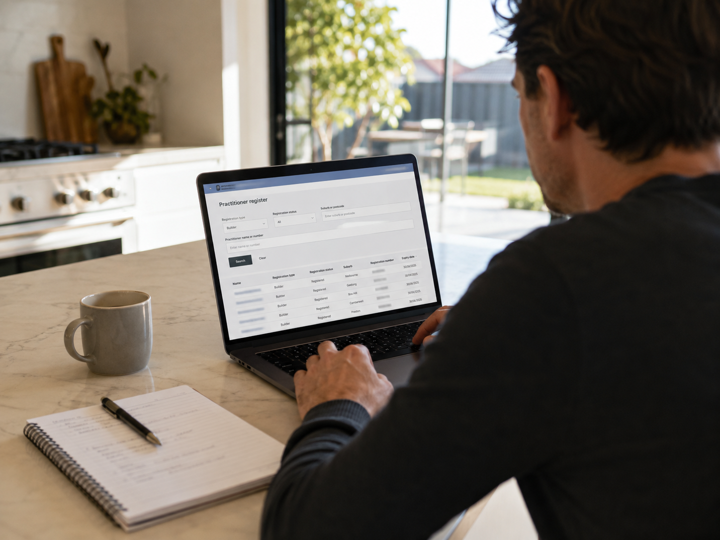 Homeowner searching the Victorian building practitioner register on a laptop