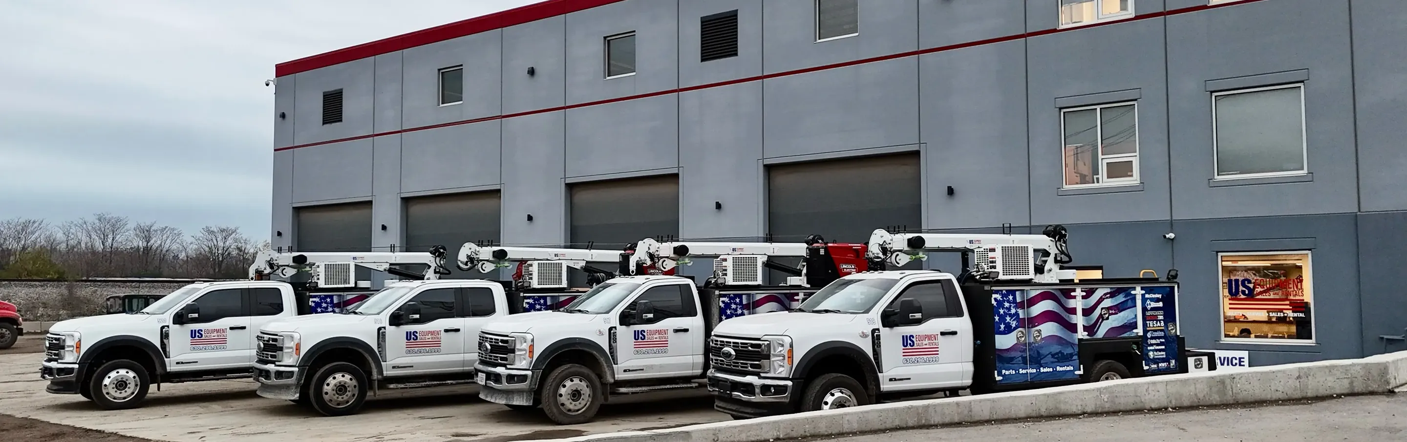 A row of trucks parked in front of a building.