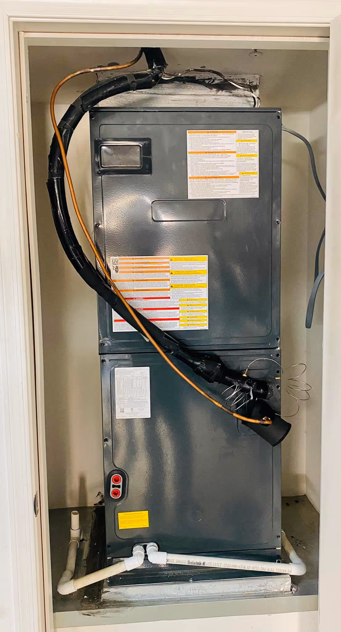 Air conditioning unit installed in a closet with electrical connections