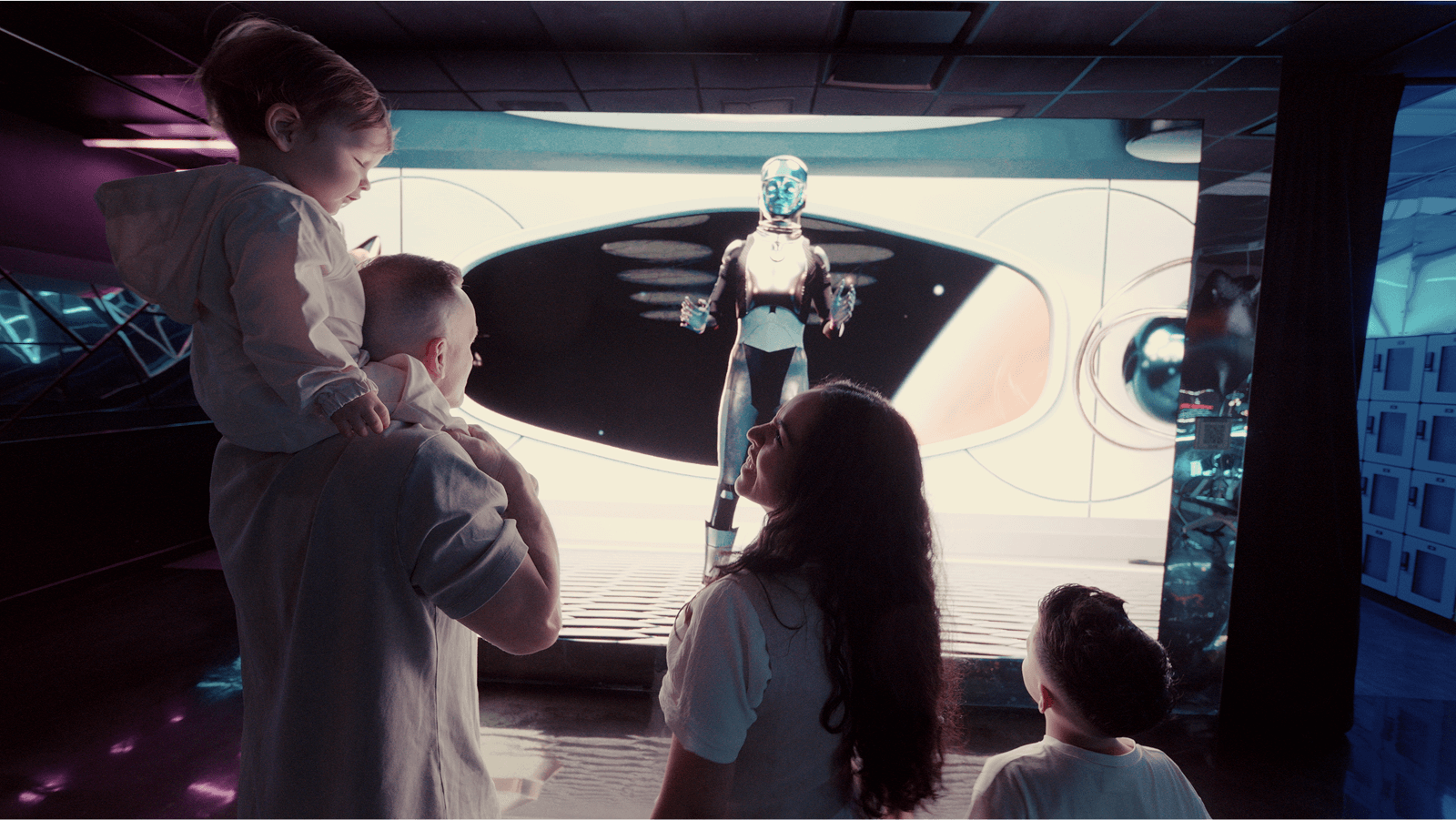 Family at INTER listening to Commander Nova's instructions, a little boy sits on his dad's shoulders