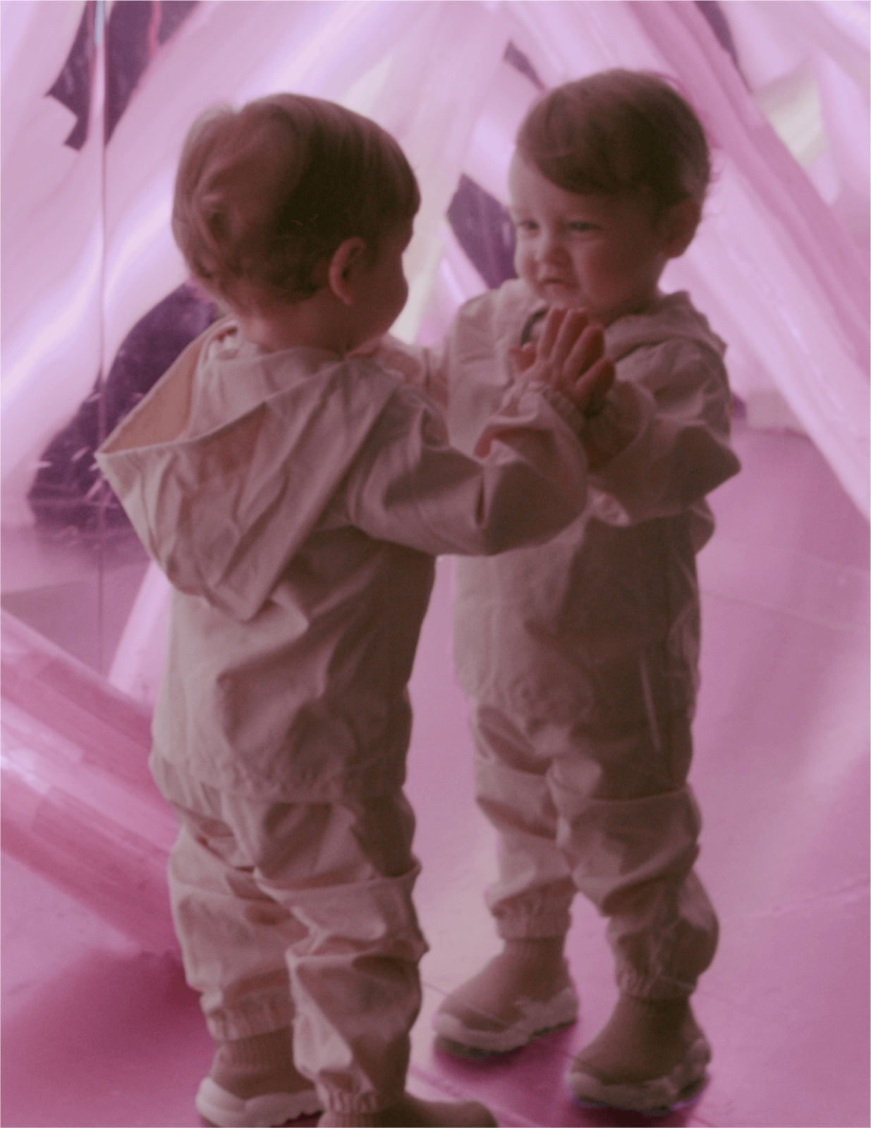 Toddler at INTER playing in a mirror