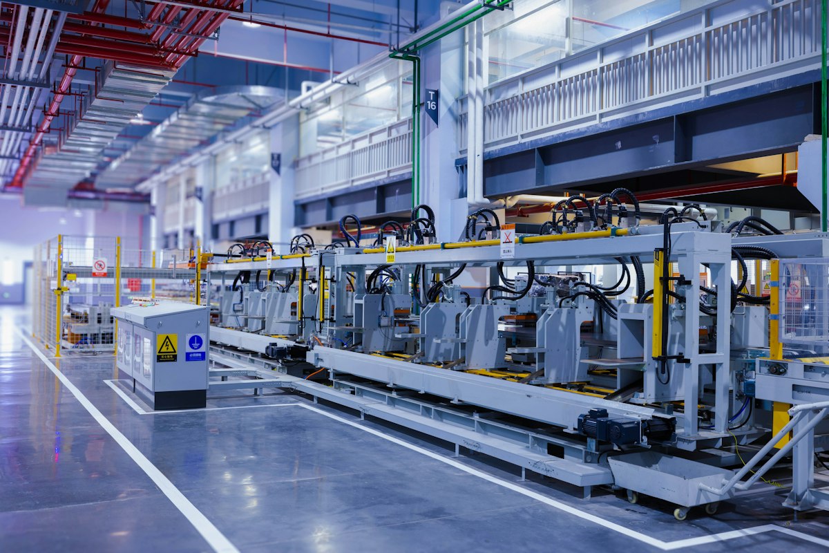 An apprentice technician learning to operate machinery on the shop floor