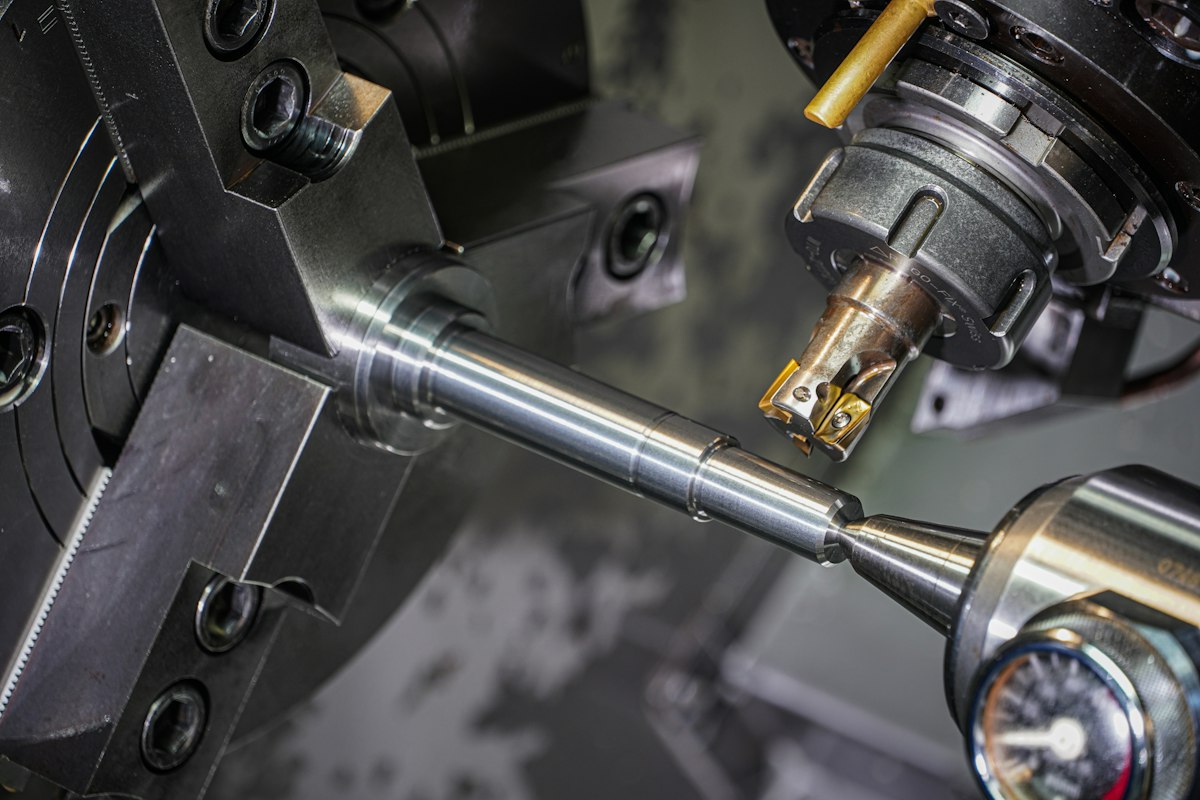 A CNC machine cutting a precision metal part during production