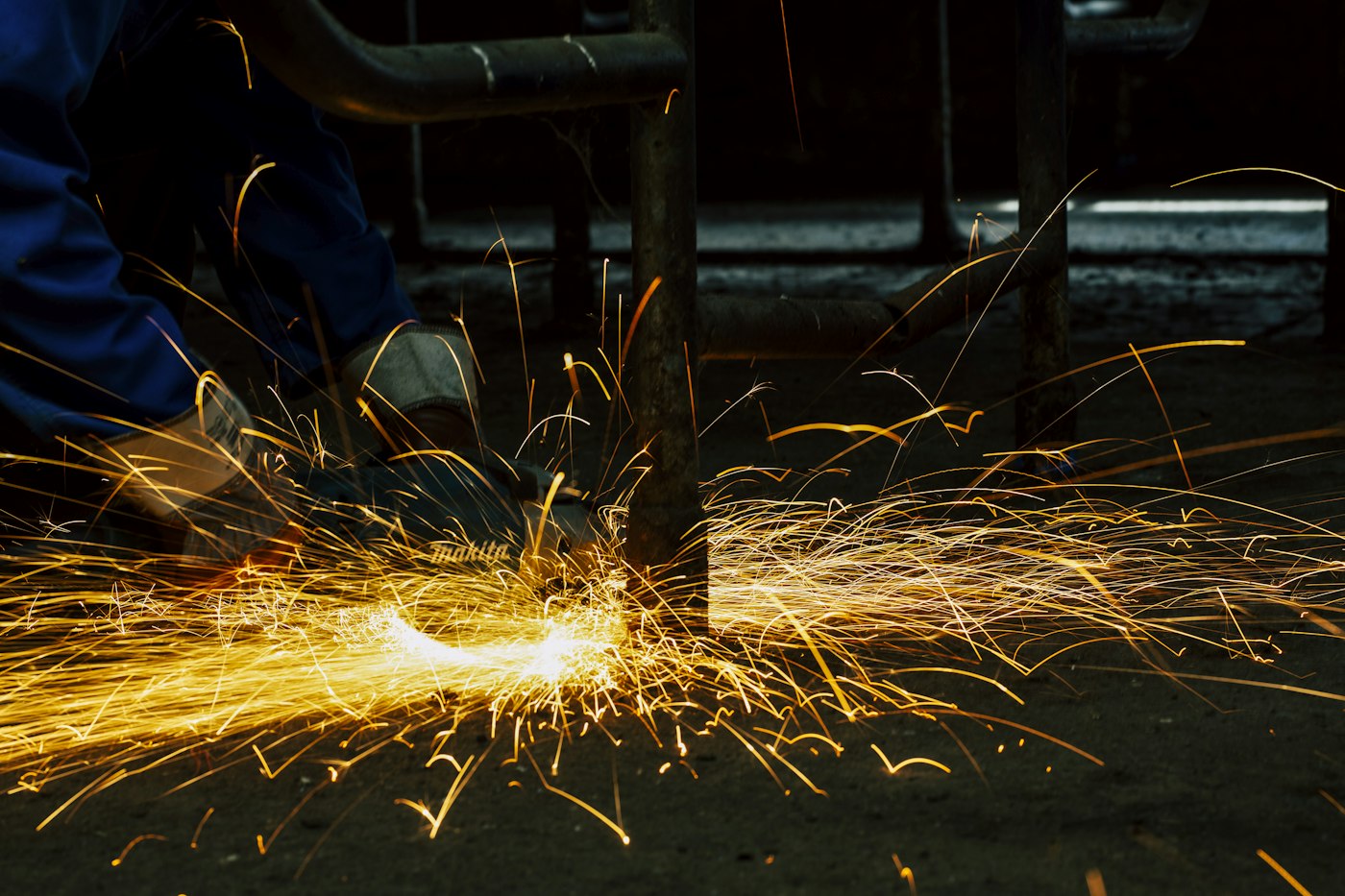 Certified welder joining metal with sparks in a Georgia shop