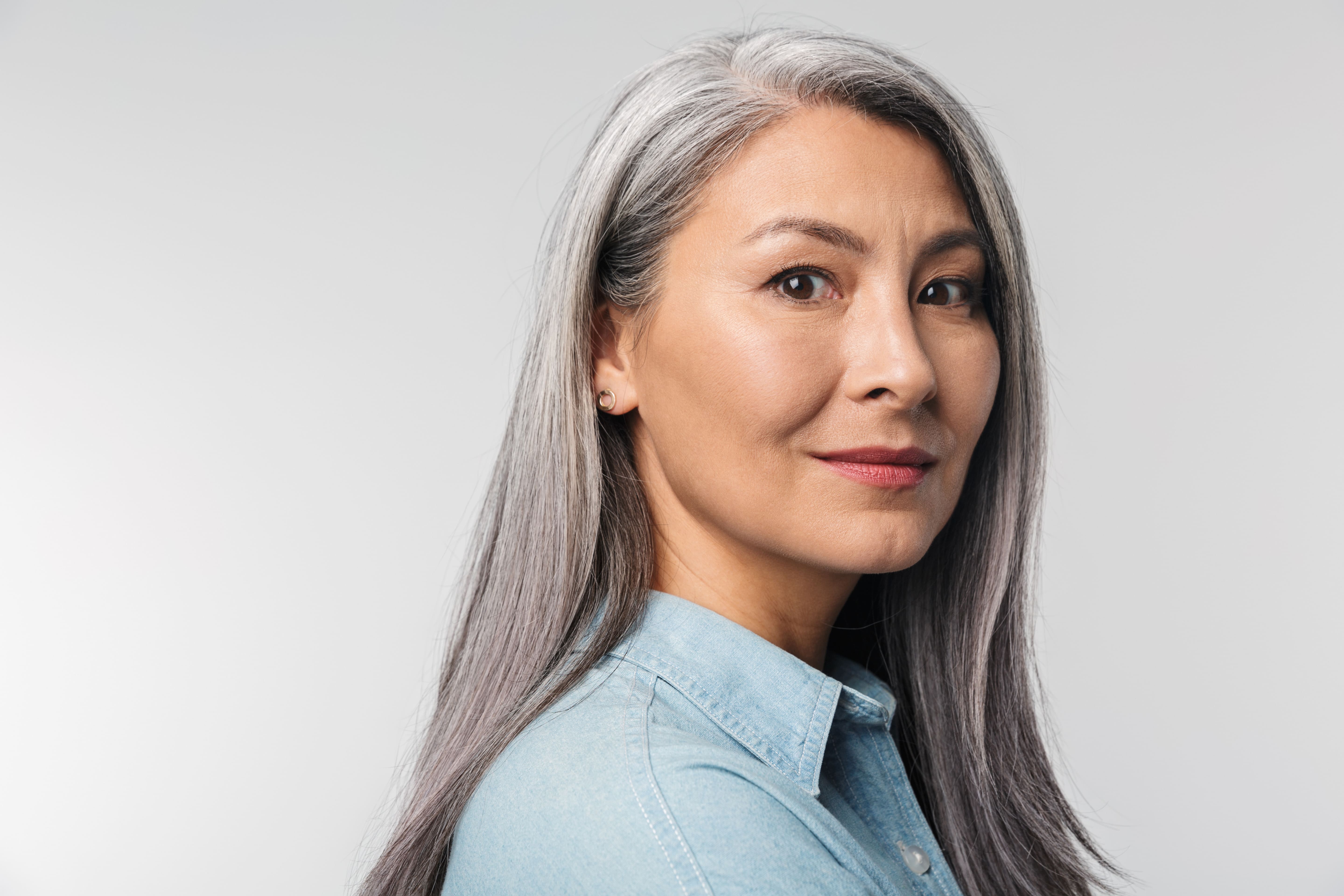 A woman with gray hair and a blue shirt.
