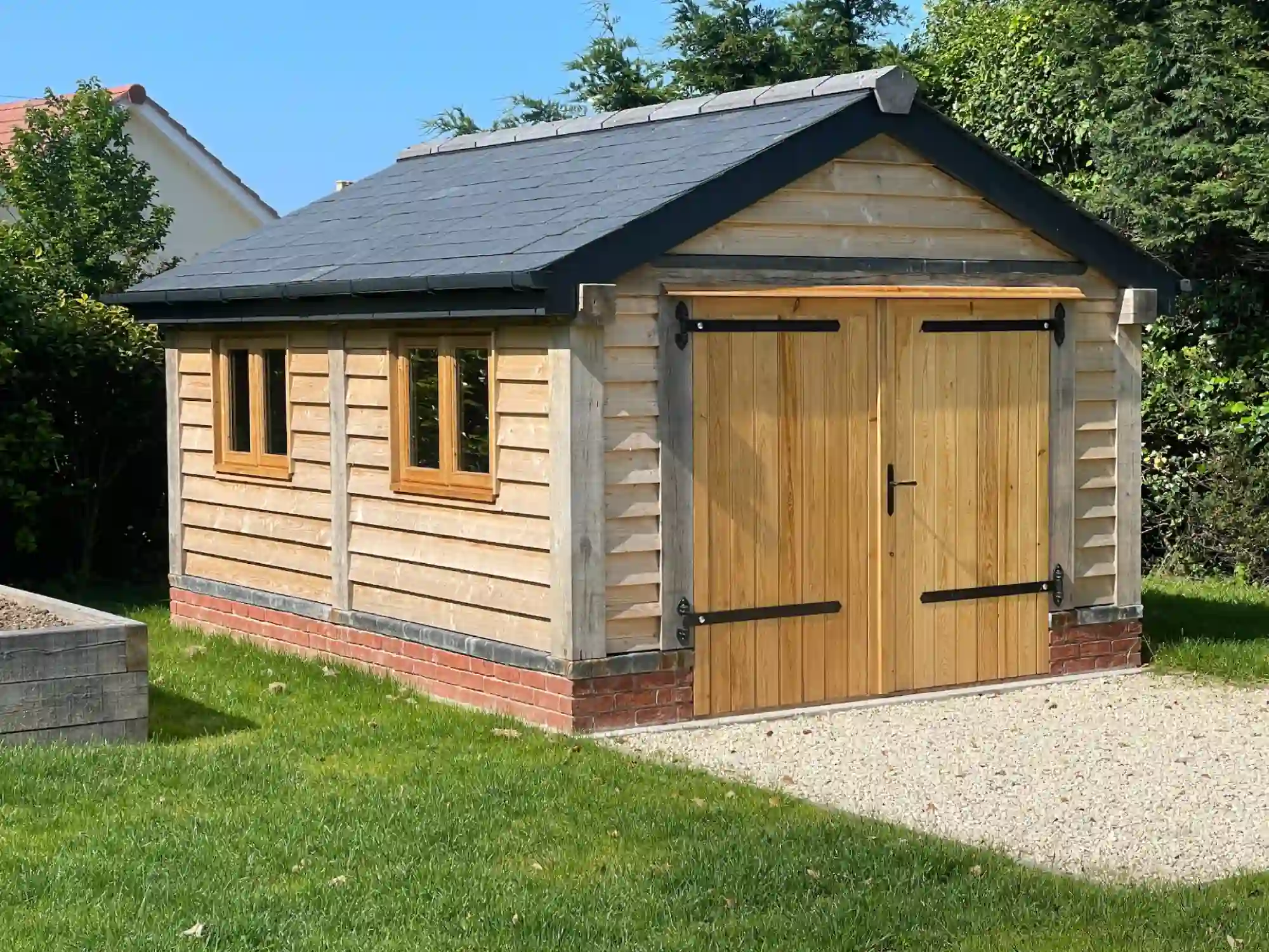a modern oak shed on a brick base
