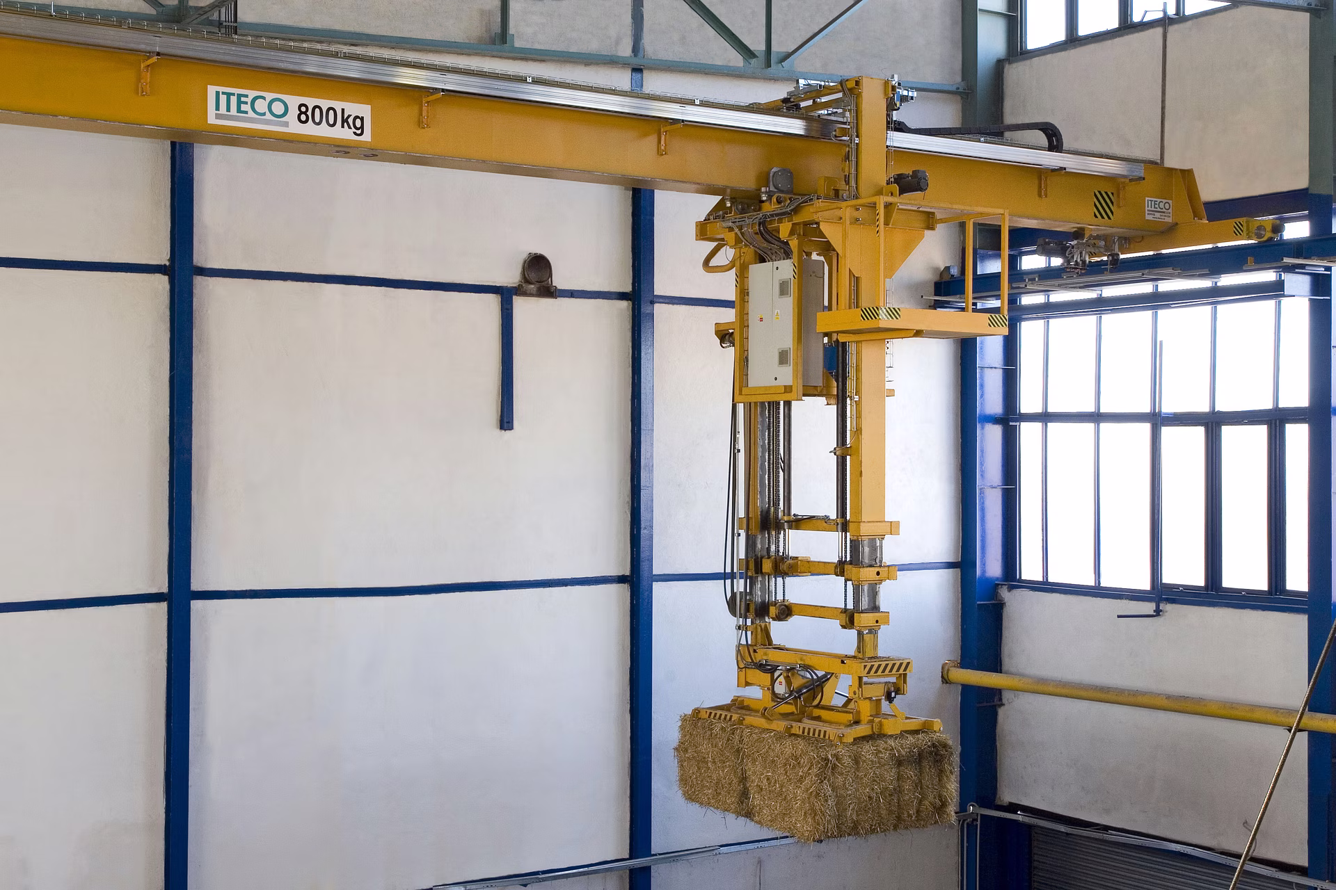 Detail zavěšení traverzy s balíkem slámy – technologie manipulace v hale