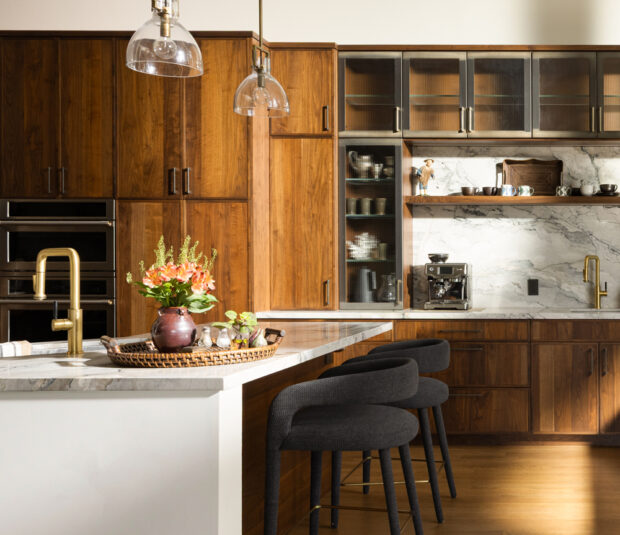 Modern kitchen with vaulted ceiling, wood beams, open shelving, and round dining table