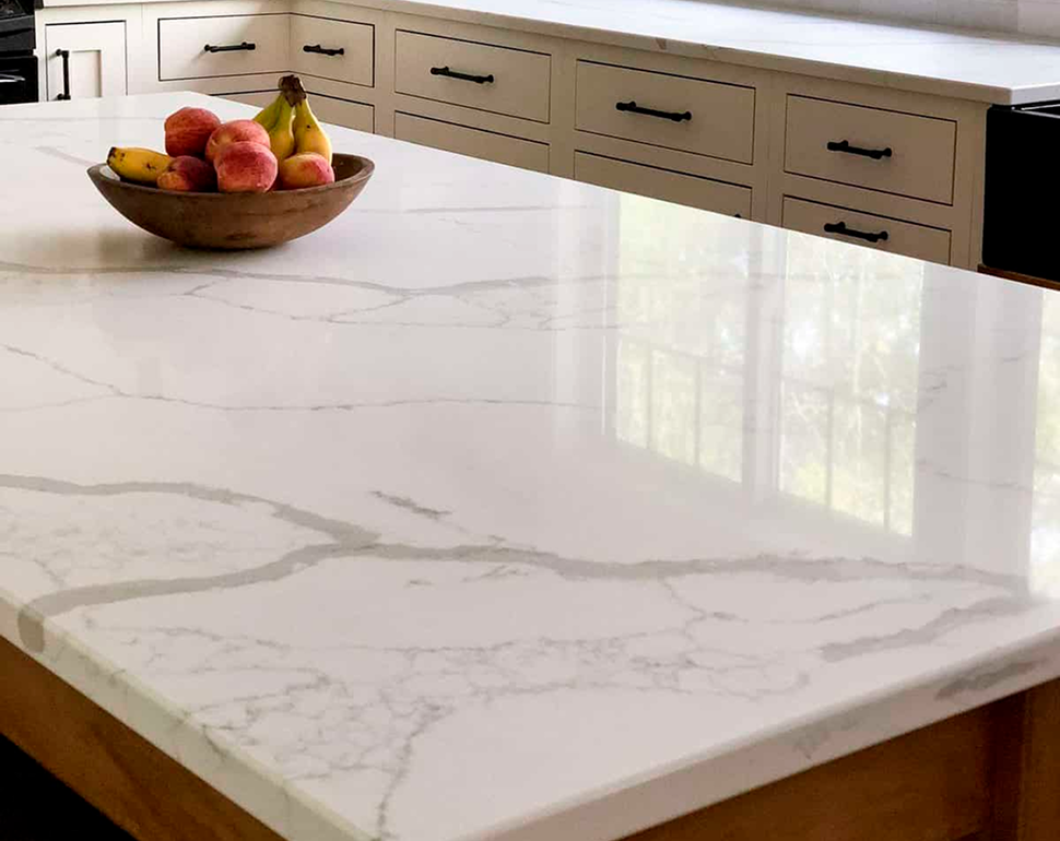 White quartz kitchen island countertop with a bowl of fruit