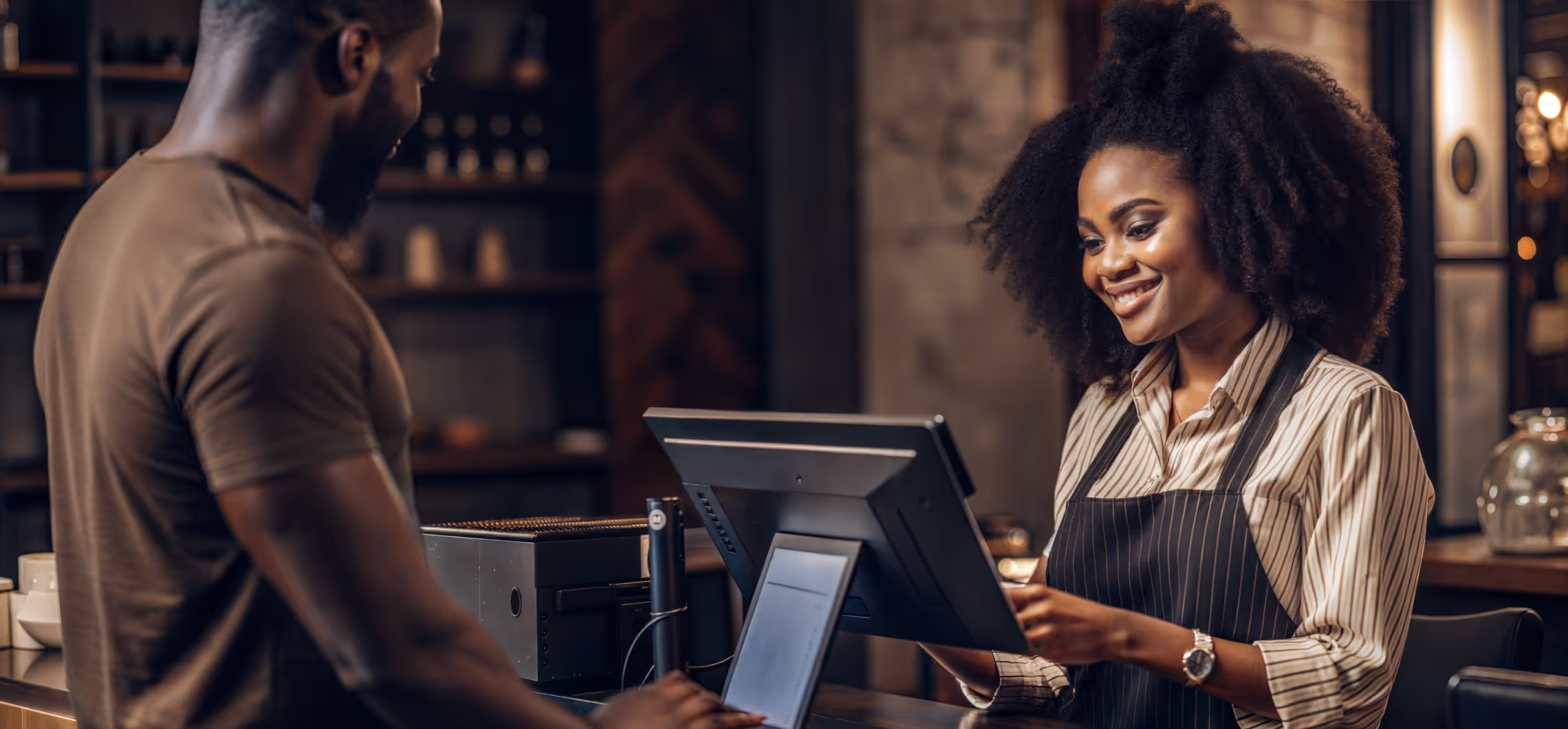 A budtender and cannabis shopper during a checkout experience.
