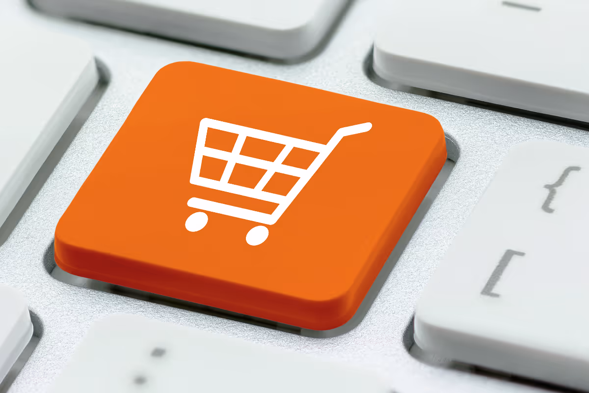keyboard with bright orange key featuring a shopping cart