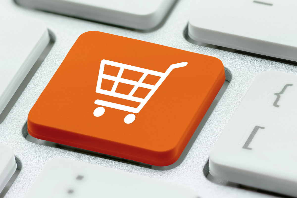keyboard with bright orange key featuring a shopping cart