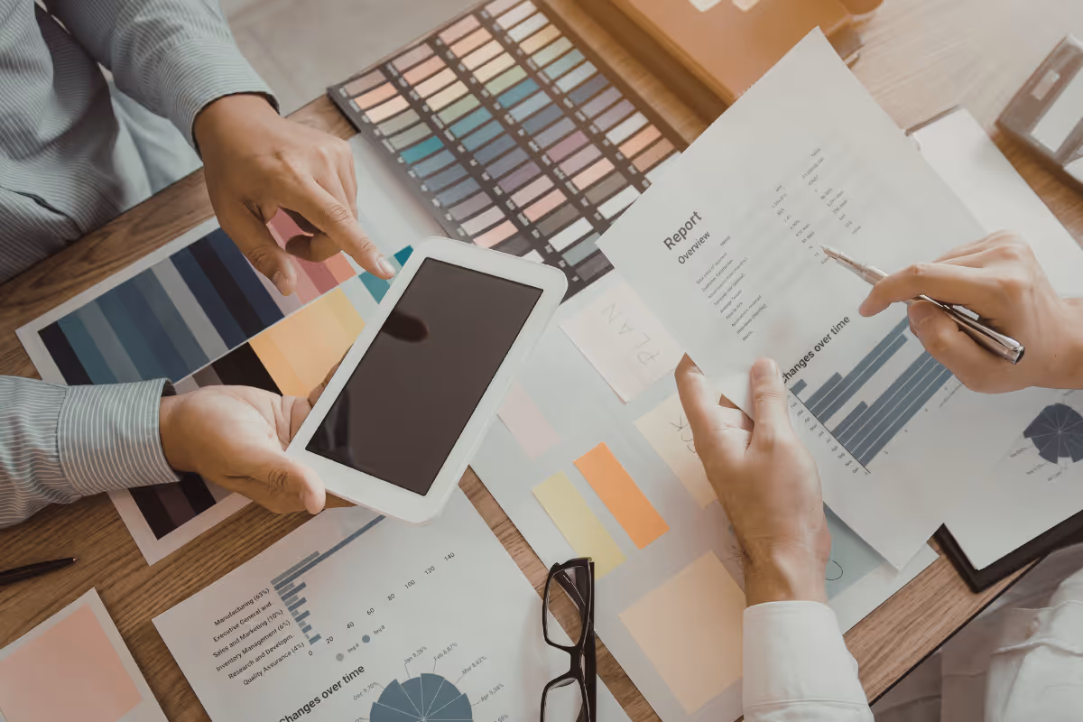 two professionals examining marketing plans and reports