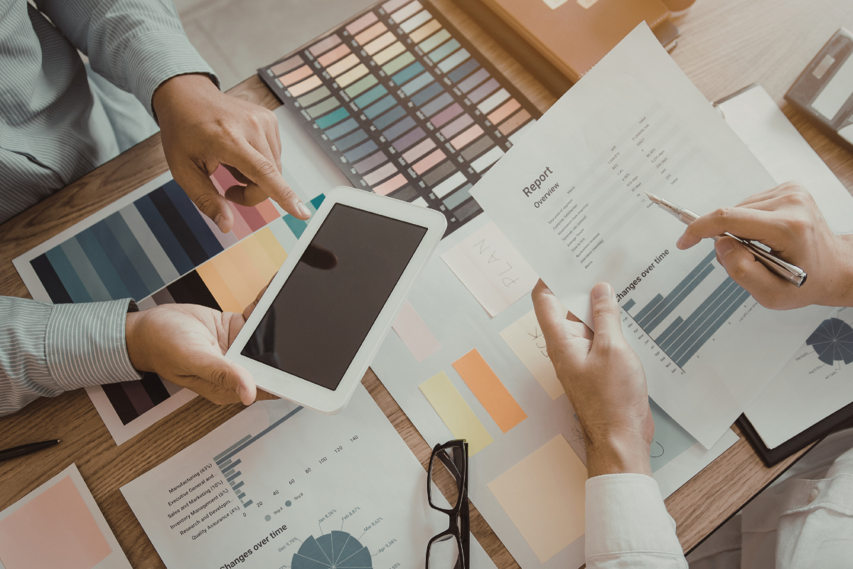 two professionals examining marketing plans and reports