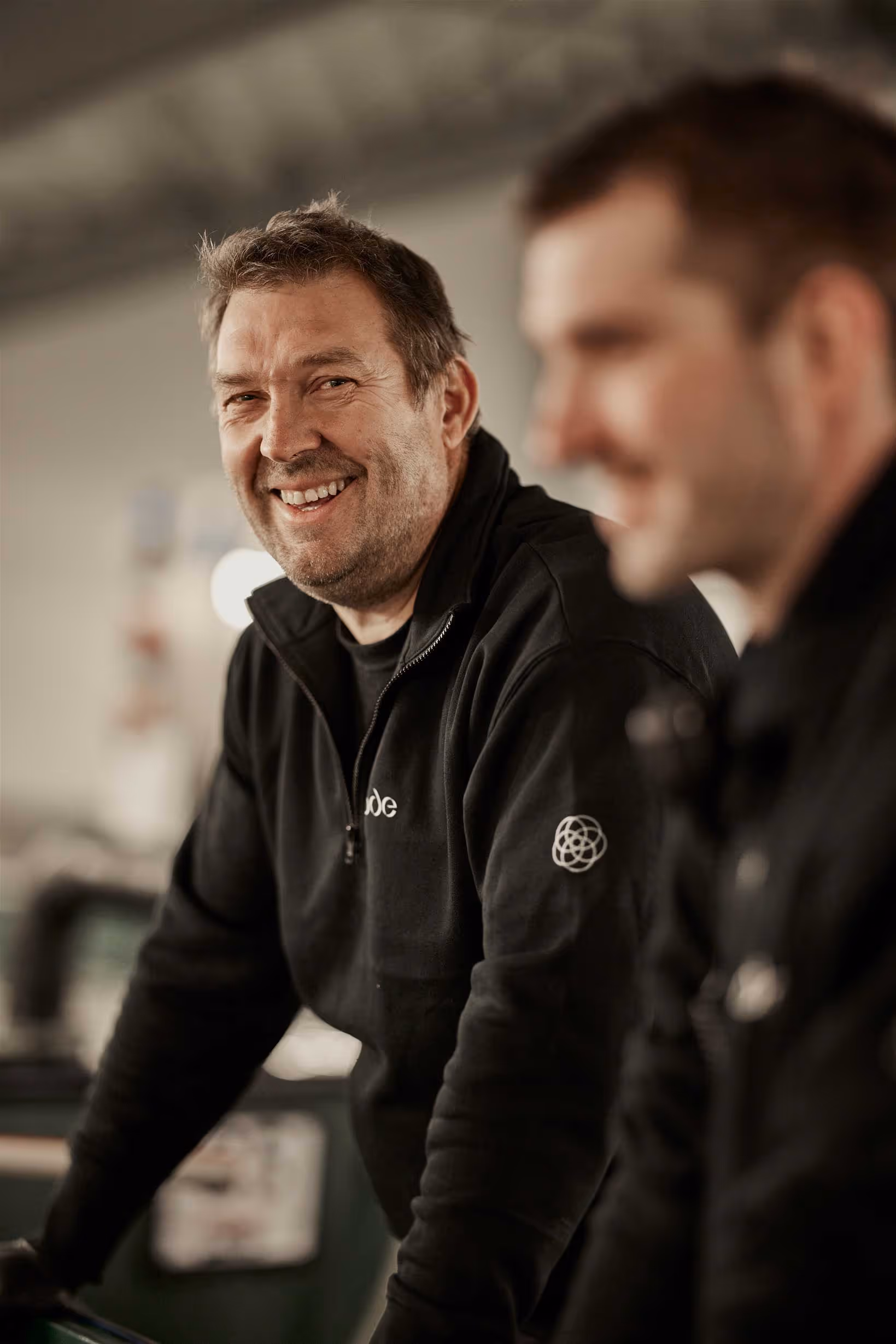 Close up portrait of two smiling Ode workers