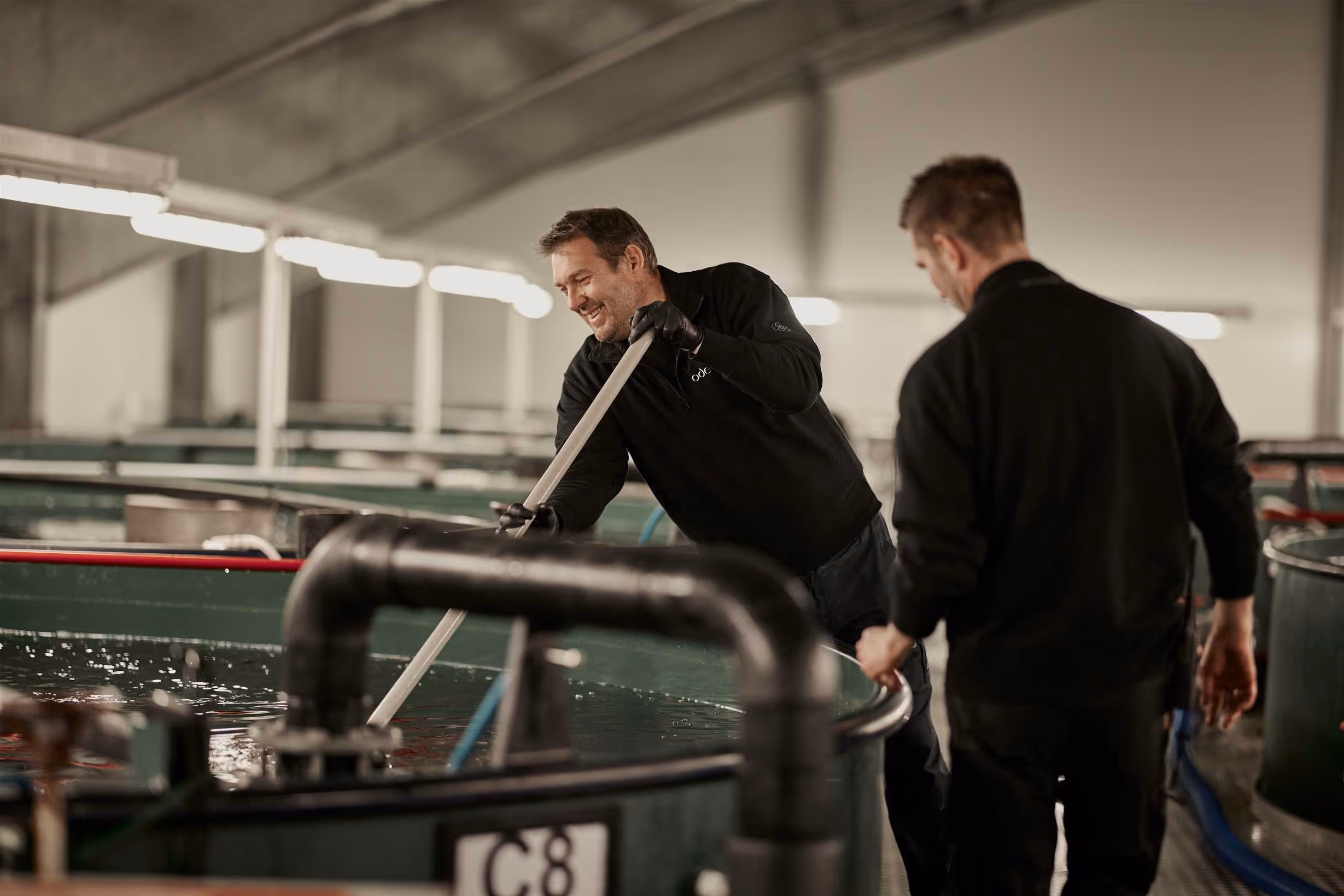 Two people working in the hatchery
