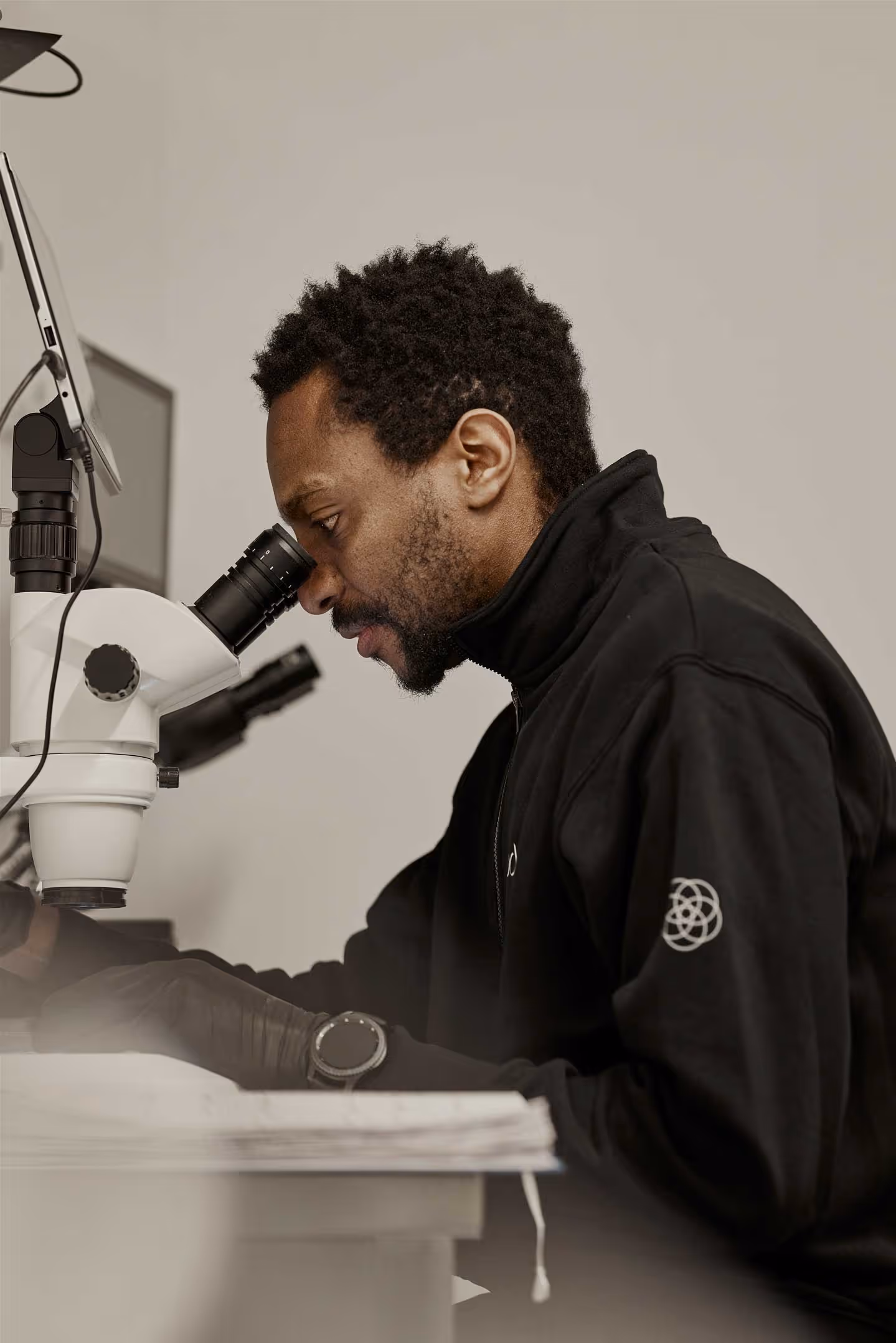 Employee looking through a microscope