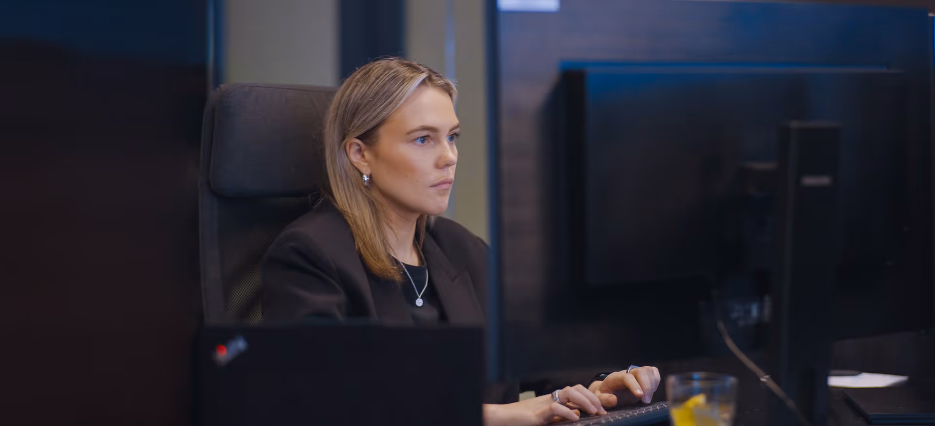 Person sitting by screen in an office