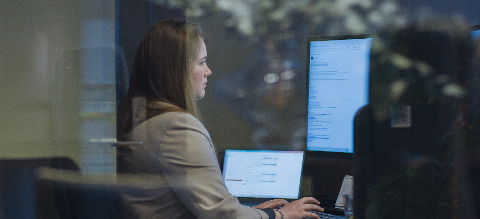 Person sitting by screen in an office