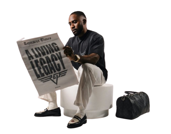 Man sitting on a stool reading a newspaper titled A Living Legacy.