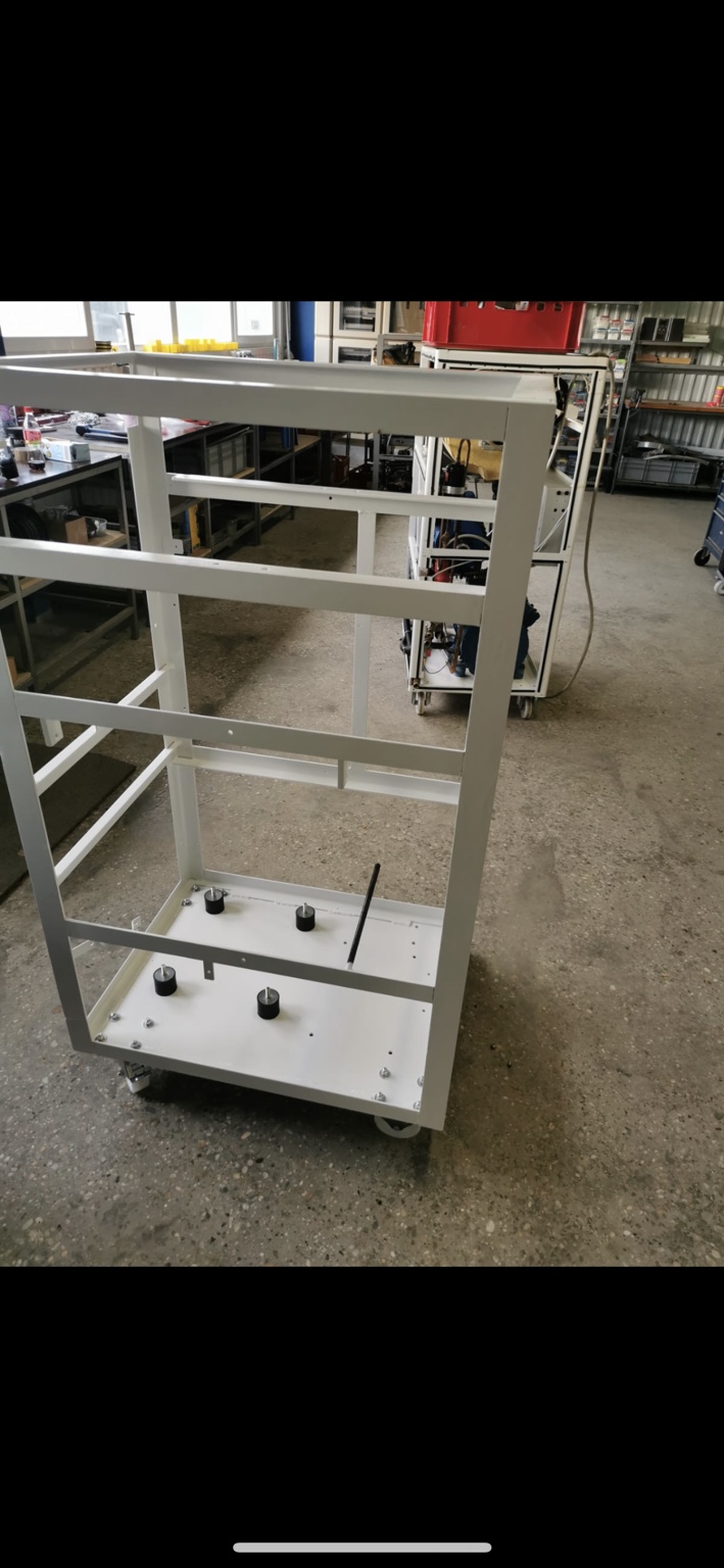 Refurbished machine frame with white paint in the workshop.