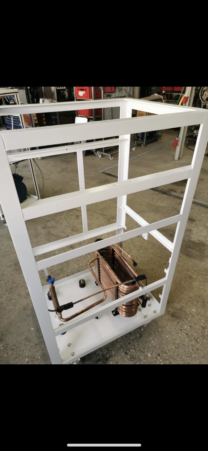 Refrigeration components being installed in the painted frame.