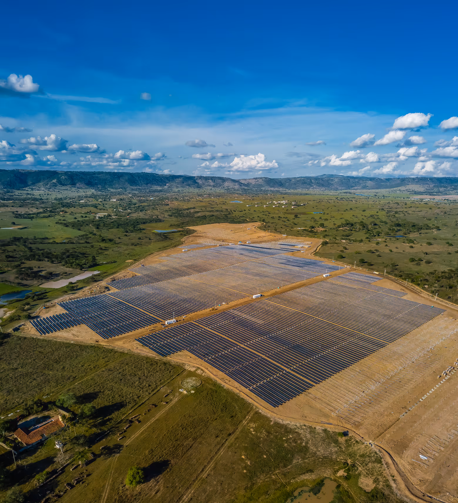 Utility solar project featuring LONGi Hi-MO 7 modules near a European rural village
