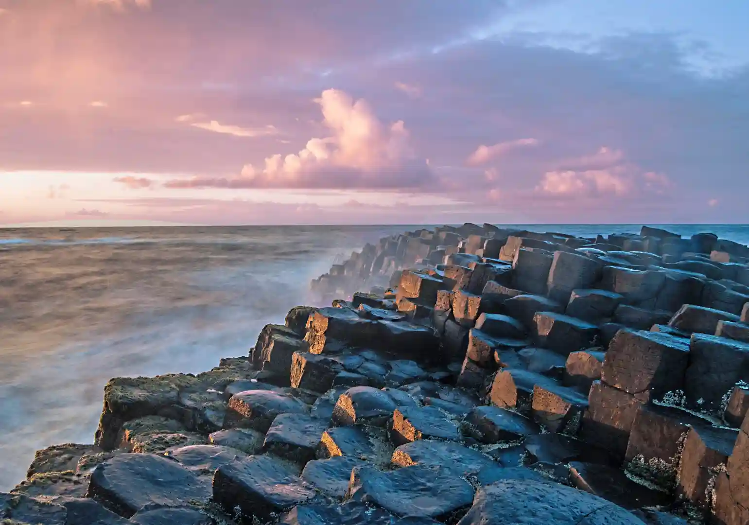 Walking trail along the cliffs of the Giant’s Causeway UNESCO World Heritage Site on Northern Ireland’s Causeway Coast, overlooking the Atlantic Ocean.