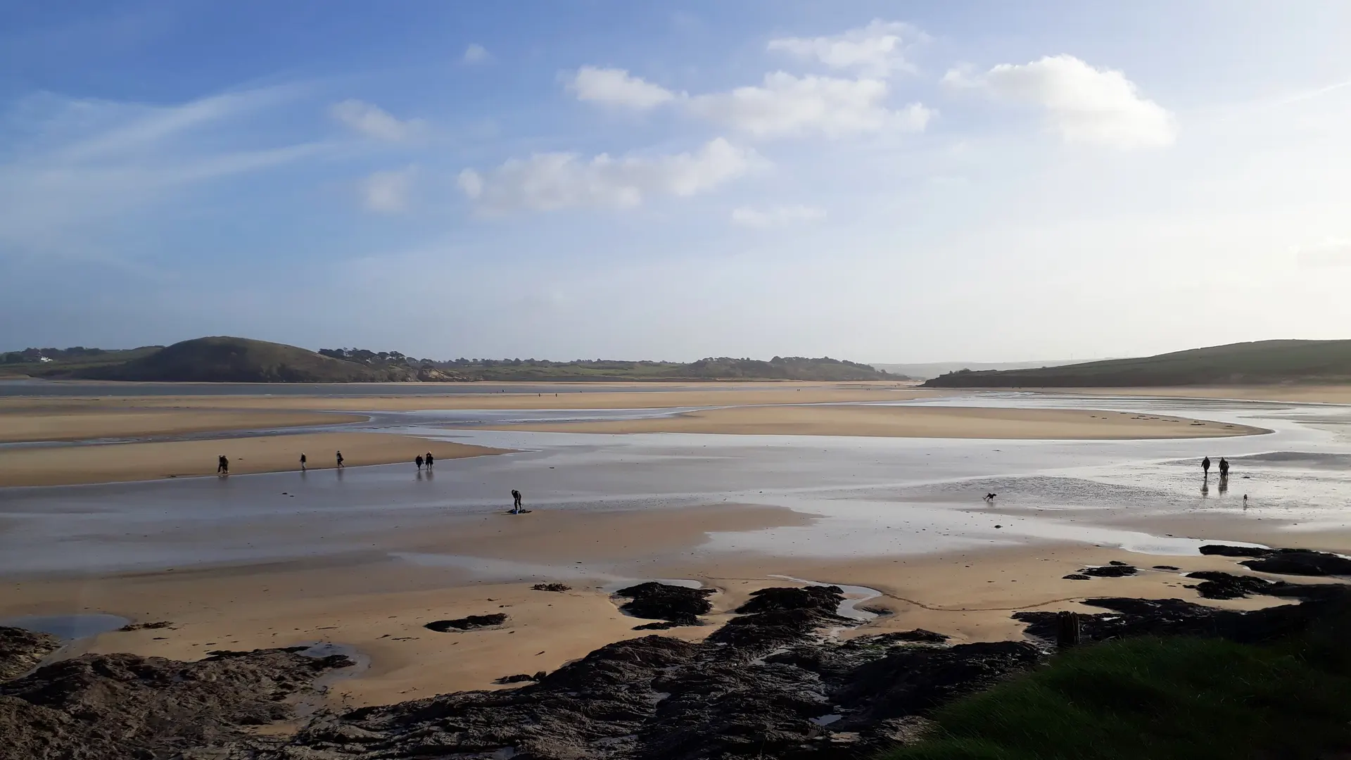 Wide sandy estuary at low tide near Padstow, Cornwall, marking the starting point of the Saints’ Way walking trail.
