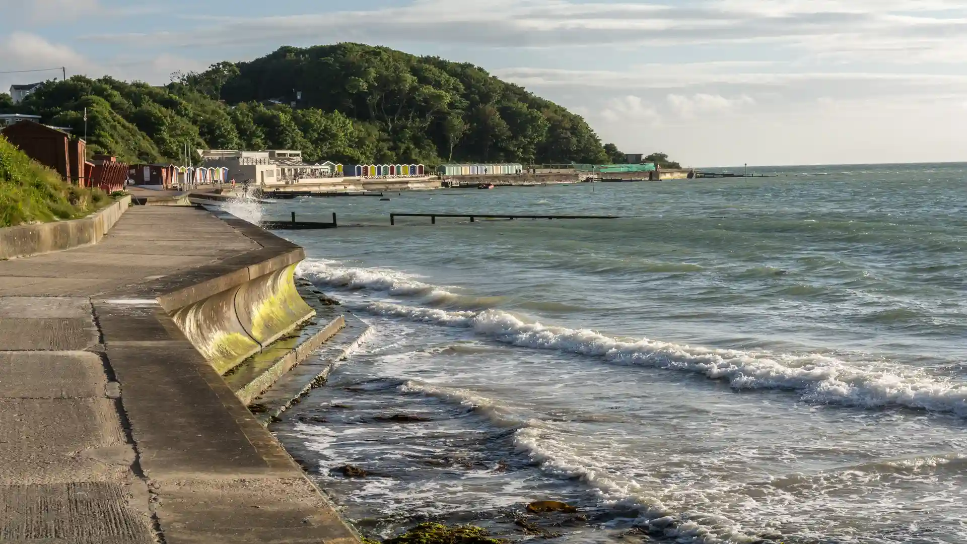 Seafront and beach huts at Colwell Bay, Isle of Wight, on the new England Coast Path section from Chilton Chine to Colwell Chine.