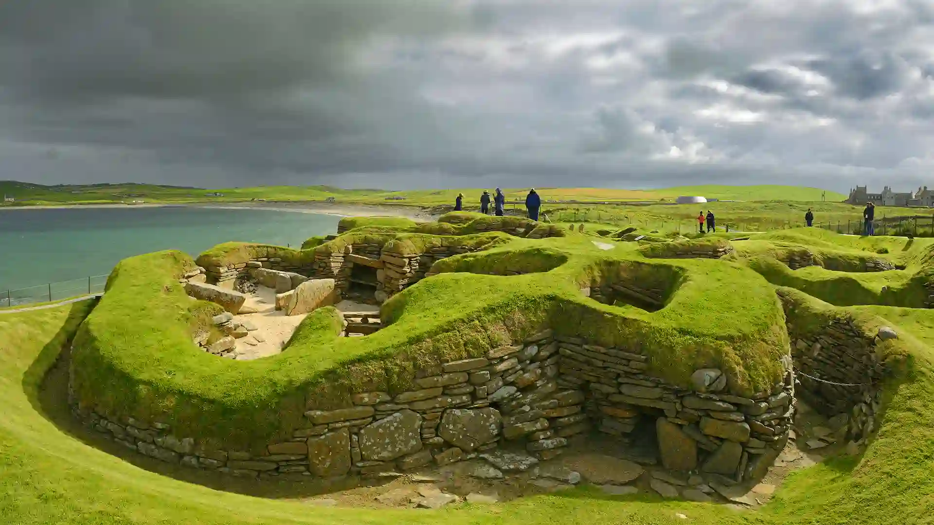 Ancient stone dwellings at Skara Brae overlooking the sea in Orkney, Scotland, part of the Heart of Neolithic Orkney UNESCO World Heritage Site.
