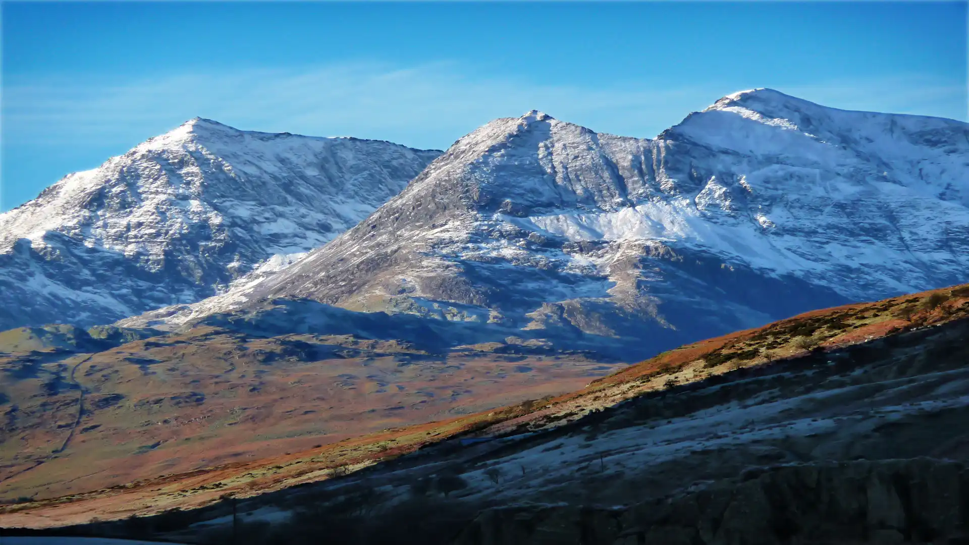 Snow-covered peaks of the Snowdon Horseshoe in Eryri (Snowdonia) National Park, North Wales.