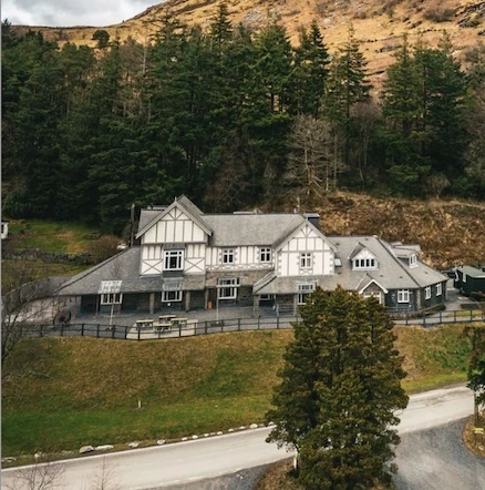 Plas Weunydd Hotel at Blaenau Ffestiniog, set against wooded hillsides in Eryri (Snowdonia) National Park, Wales.