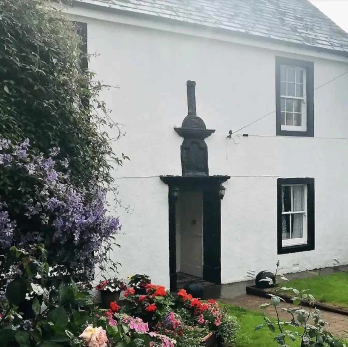 Stonehouse Farm in St Bees, a traditional whitewashed guesthouse with a flower-filled garden, popular with walkers starting the Coast to Coast Path.