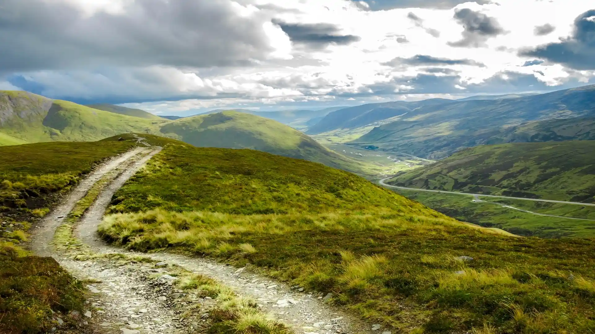 Mountain trail overlooking the wide glens and rolling hills of Deeside in the Cairngorms National Park, Scottish Highlands.