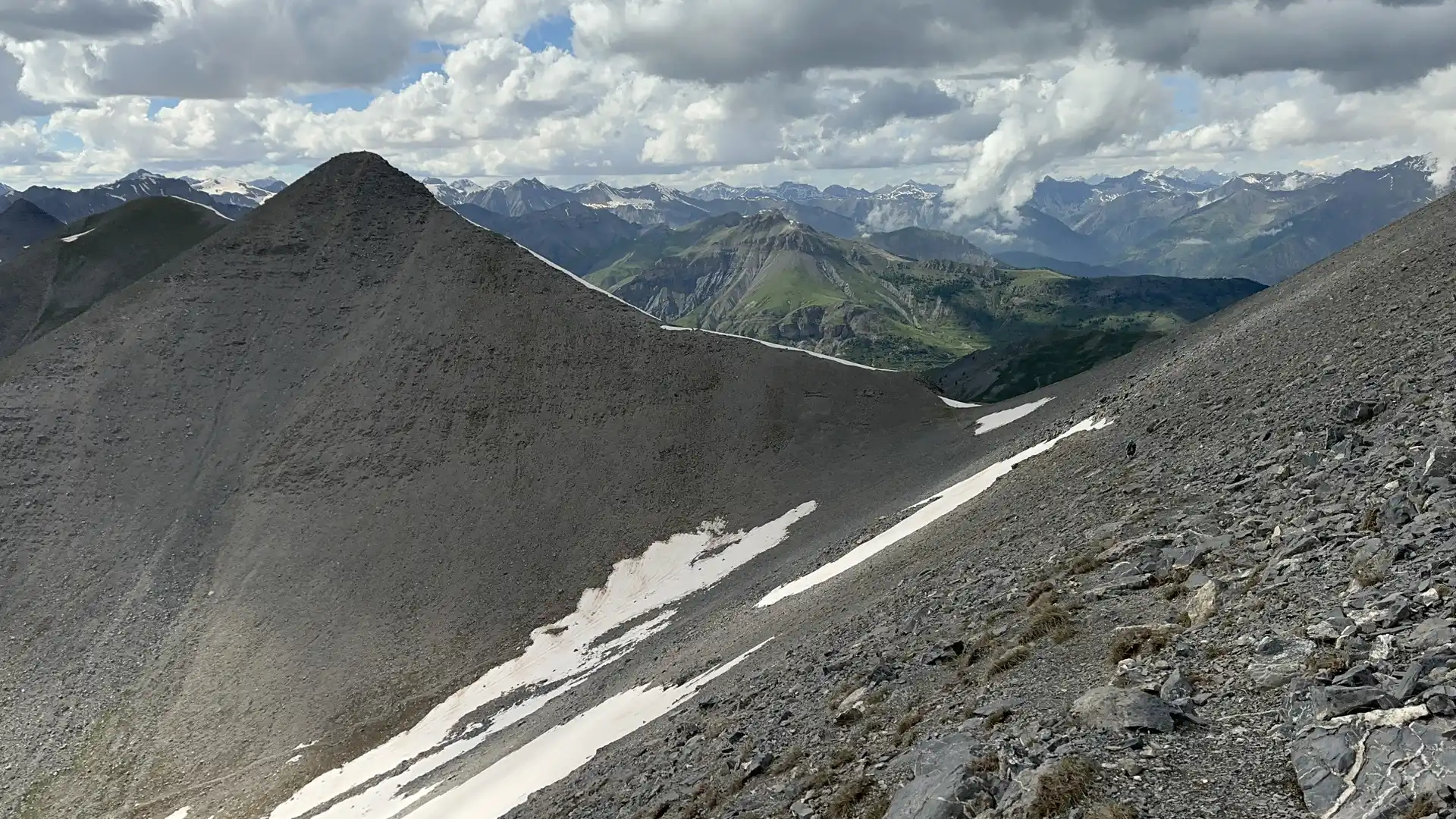 High alpine pass on the GR5 near Beuil in Mercantour National Park, French Alps, with rocky ridgelines and distant mountain peaks.