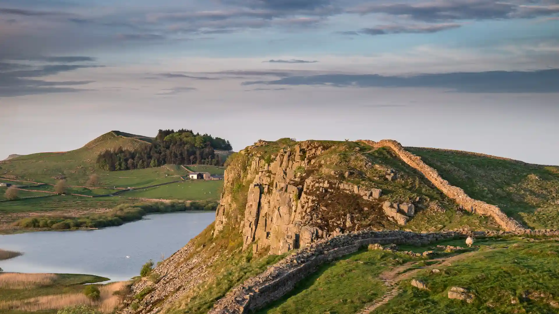 Hadrian’s Wall winding along rocky crags and open upland scenery in Northumberland National Park, England.