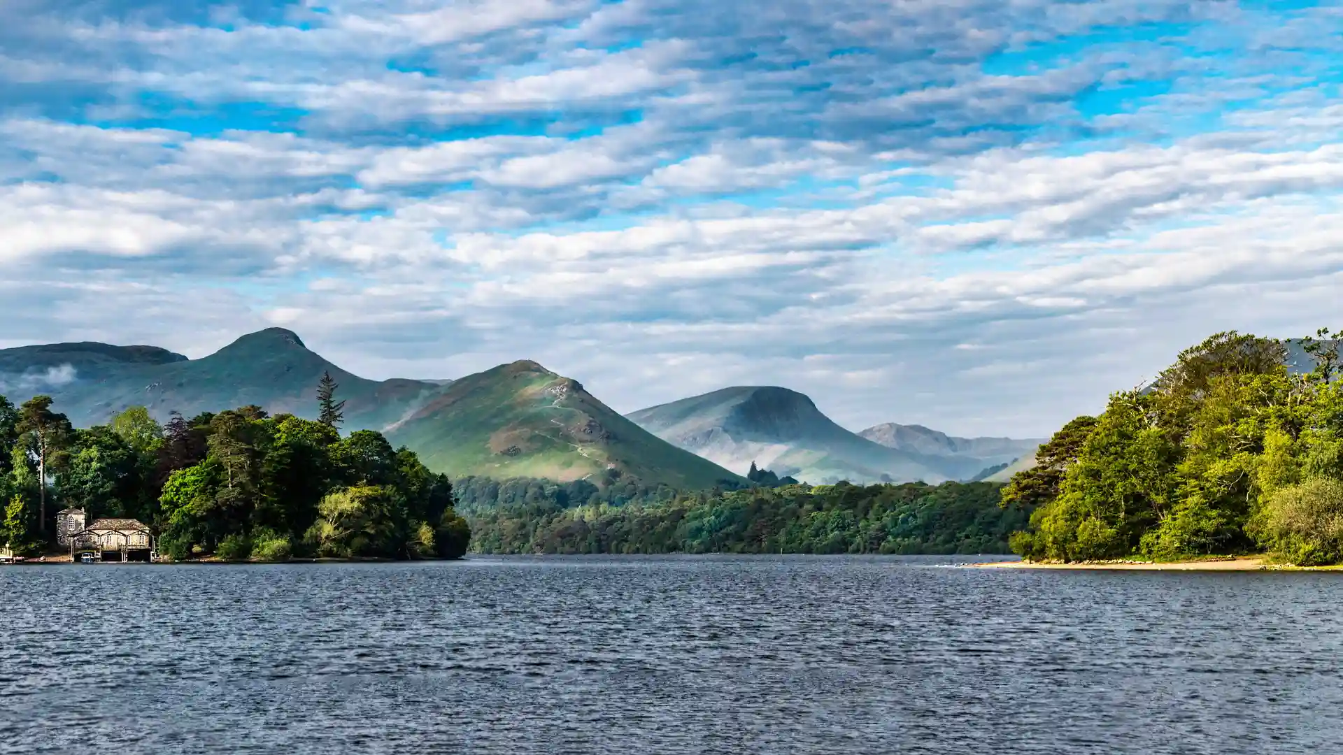 Derwentwater with wooded shoreline and surrounding fells in the Lake District National Park, Cumbria.