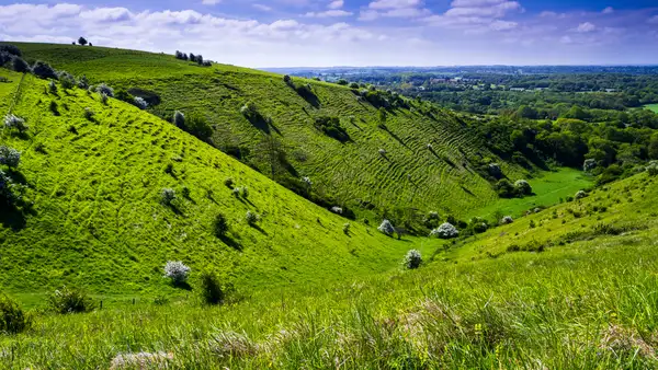 A bright sunny spring down on the Kent downs near wye looking down the valley at Devils Kneeding trough south east England.