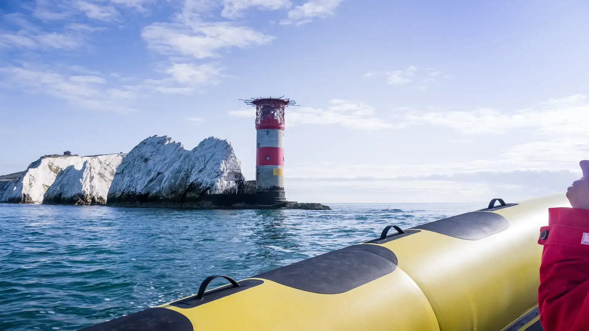 The Needles Lighthouse off the Isle of Wight as seen from an inflatable speed boat.