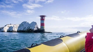 The Needles Lighthouse off the Isle of Wight as seen from an inflatable speed boat.