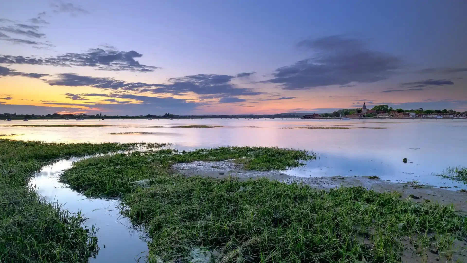Saltmarsh and tidal creeks at sunset in the Chichester Harbour National Landscape.