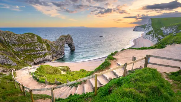 Red sandstone cliffs and coastal path overlooking a sheltered bay in the East Devon National Landscape, England