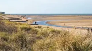 A view over Hunstanton beach on the North Norfolk coast taken from the sand dunes. Captured on a bright and sunny day in the winter.