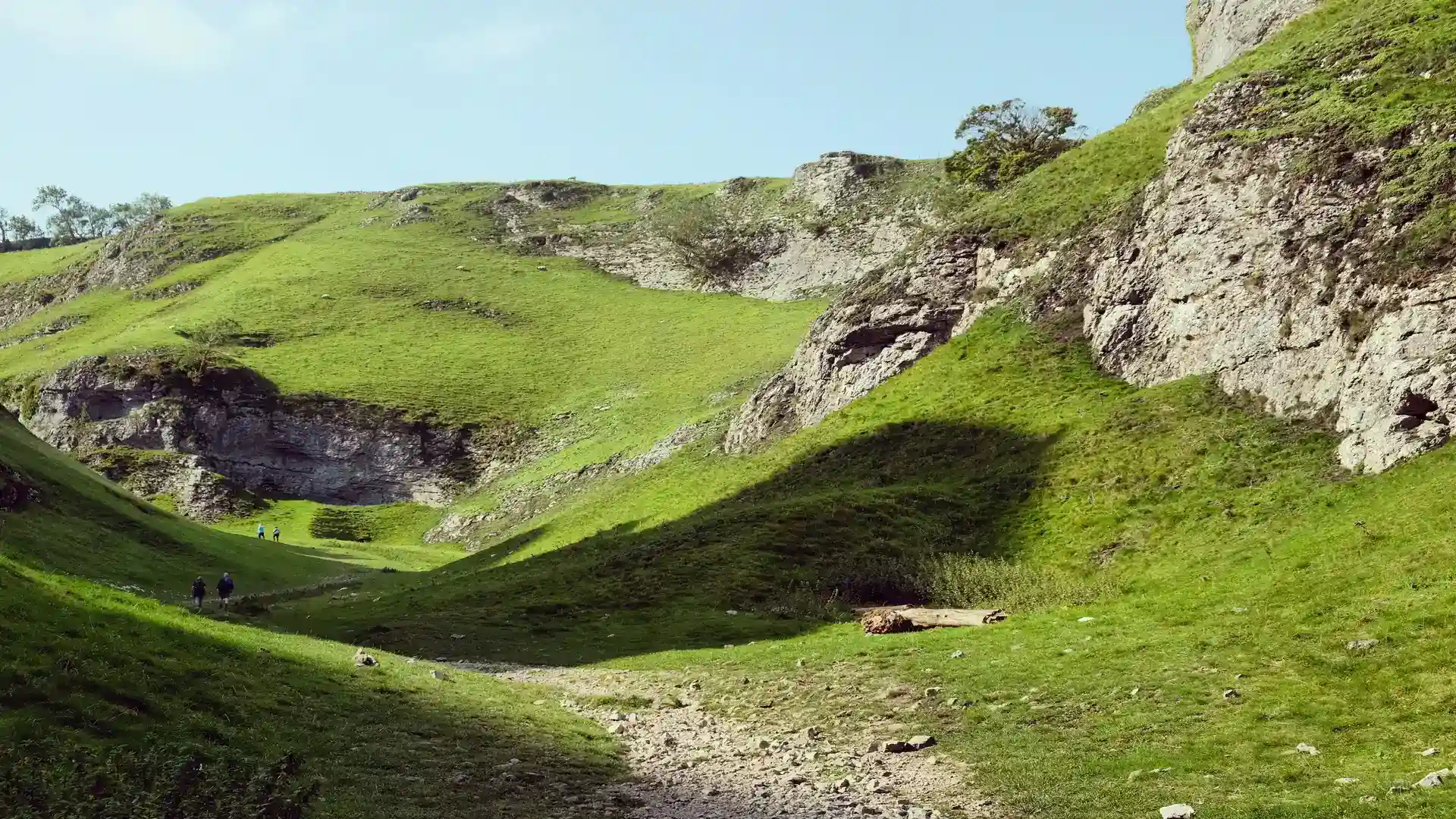 Walkers in a limestone dale on the Limestone Way in the White Peak, Derbyshire.