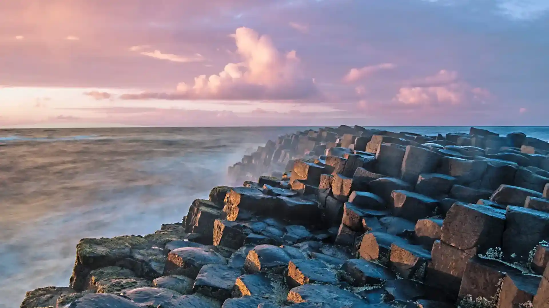 Walking trail along the cliffs of the Giant’s Causeway UNESCO World Heritage Site on Northern Ireland’s Causeway Coast, overlooking the Atlantic Ocean.