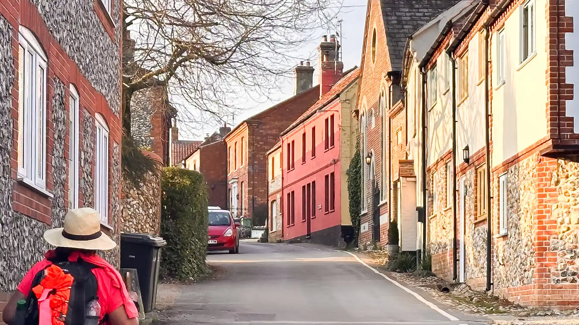 Traditional flint and brick cottages along a quiet village street in Castle Acre, Norfolk.