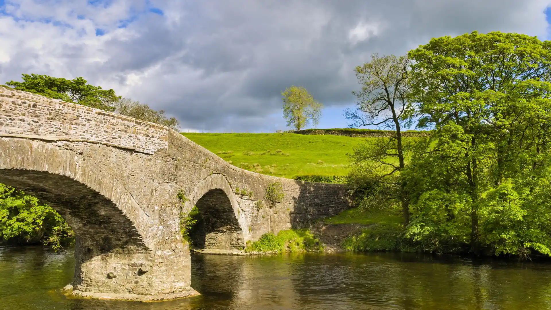 Crook of Lune Bridge crossing the River Lune along the Dales Way, surrounded by woodland and countryside in northern England.