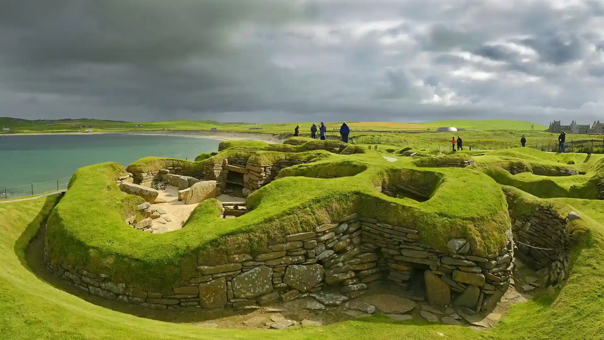 Ancient stone dwellings at Skara Brae overlooking the sea in Orkney, Scotland, part of the Heart of Neolithic Orkney UNESCO World Heritage Site.